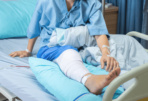 injured person sitting in hospital bed