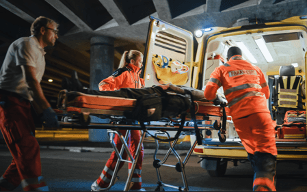 paramedics loading accident victim into ambulance