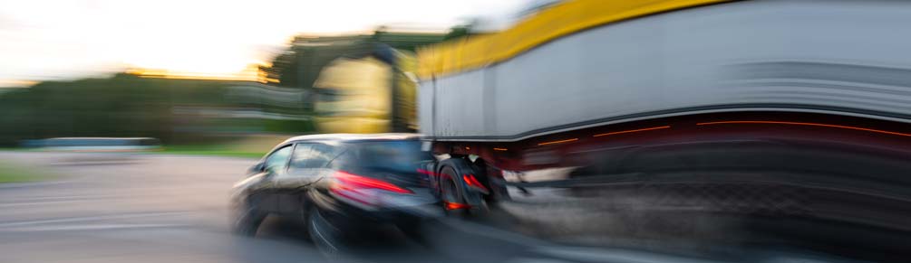 A truck and a car side by side on the road